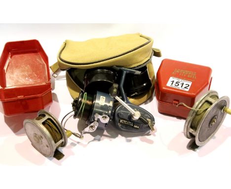 Two unnamed fly reels, two empty K D Merritts reel cases and a Mitchell 440A reel with two spare spools. P&amp;P Group 2 (£18