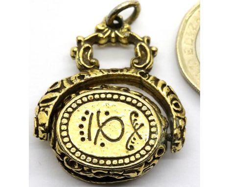 Yellow metal spinning fob with Arabic inscription, 14.5g. P&amp;P Group 1 (£14+VAT for the first lot and £1+VAT for subsequen