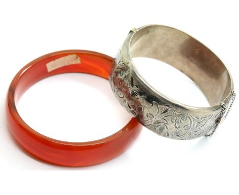 Hallmarked silver bangle and a red agate bangle. P&amp;P Group 1 (£14+VAT for the first lot and £1+VAT for subsequent lots) 