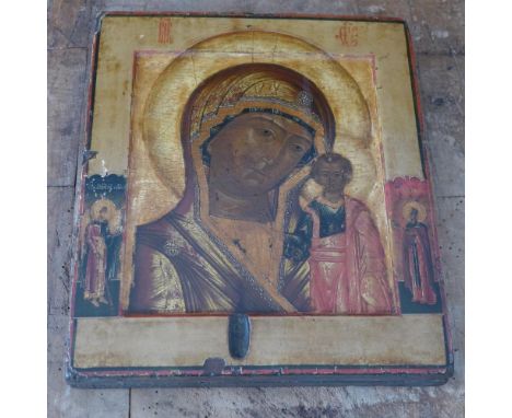 A Russian icon, The Mother of God of Kazan, flanked by saints to the polya, tempera on wood panel, parcel gilded, 31 x 26cm (