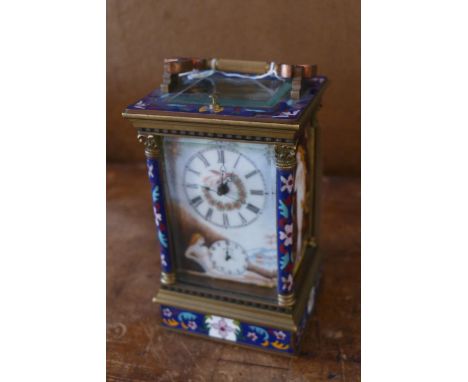 A gilt brass and cloisonne enamel carriage clock, Roman dial painted with a dove and a nude lady in a landscape scene, having