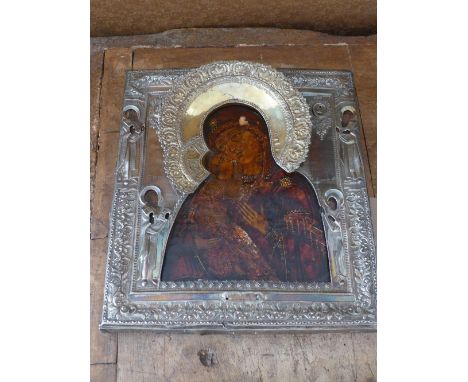 A Russian icon, The Vladimirskaya Mother of God, tempera on wood panel with silver oklad having silver gilt halo, hallmarked,