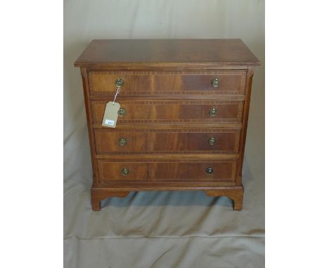 A Georgian style mahogany chest, with four graduating drawers, raised on bracket feet, bearing label for Shaw of London, H.77