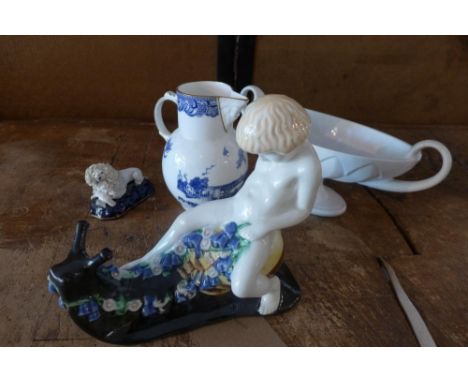 A ceramic child riding a snail, monogrammed to base, a ceramic poodle, a Coalport jug and a Constance Spry twin handled vase 