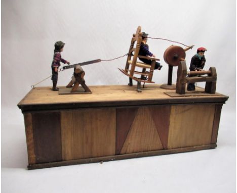 Handmade electrically operated automaton of wood cutters, lathe turner, and man seated in a rocking chair L65cm H44cm complet
