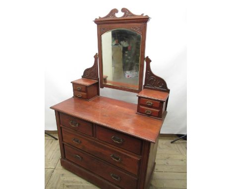 Early C20th mahogany dressing table, swing bevel edged mirror supported by carved scroll arms above four trinket drawers and 