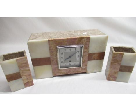 An Art Deco period three piece variegated marble and onyx clock garniture. Martini eight day movement 