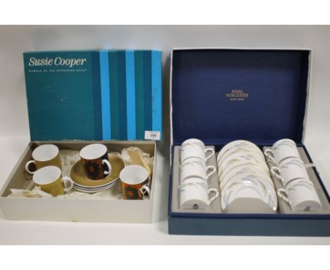 A BOXED SET OF FOUR SUSIE COOPER CUPS AND SAUCERS TOGETHER WITH A BOXED SET OF SIX ROYAL WORCESTER HARVEST RING CUPS AND SAUC