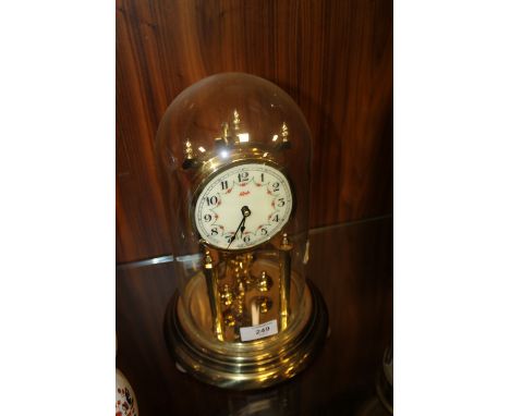 A GLASS DOMED KUNDO MANTEL CLOCK