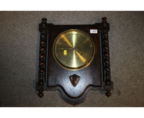 AN OAK BARLEYTWIST WALL HANGING BAROMETER 