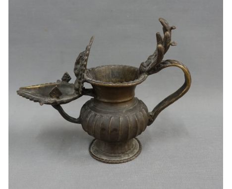 Bronze Sukunda oil lamp with a globular fluted body and everted rim, the thumb rest in the form of Vishnu and five snakes, 15