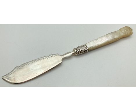 An early Victorian silver butter knife with mother of pearl handle. With decorative silver mount and carved shell shaped fini