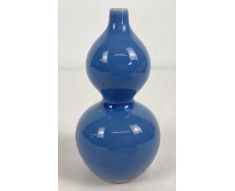 A small Chinese ceramic bottle gourd shaped bud vase with blue glaze. Signature marks to underside. Approx. 11.5cm tall. 