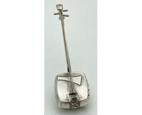 A novelty silver shaker in the form of a 3 stringed Japanese Shamisen. Marked to reverse 'Silvercraft' and Sterling. With ope