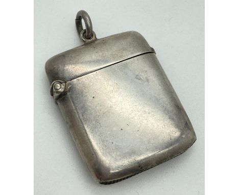 An Edwardian silver curve backed vesta case hallmarked for G. Loveridge, B'ham 1902. With hanging bale to lid and striking pa