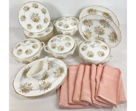 A quantity of modern ceramic dinner ware with peach floral design. Together with a table cloth and napkins. Dinner ware compr