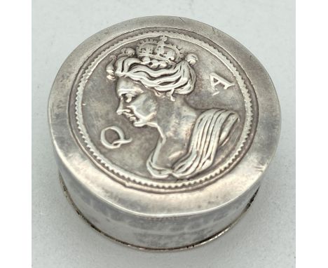 A small silver circular shaped patch box with portrait of Queen Anne shown in relief to lid. Worn makers mark to underside. A