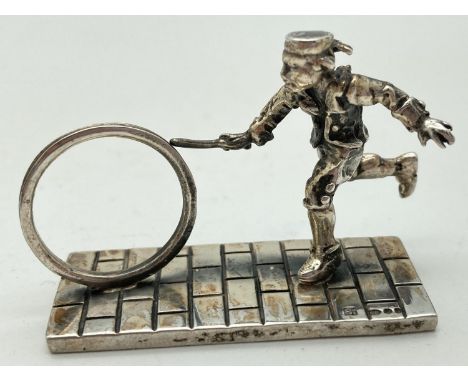 A small silver figurine of a Victorian child playing Hoop &amp; Stick. Hallmarked to base with 925, makers mark and London im