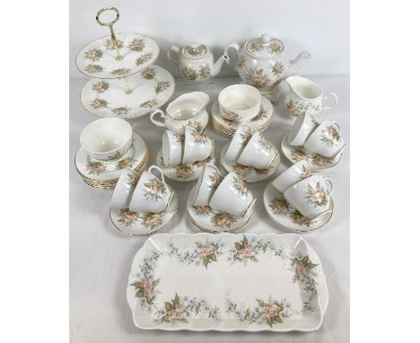 A collection of modern ceramic tea ware with a peach flower design. Comprising: 12 x cups &amp; saucers, 12 x 6.5" side plate