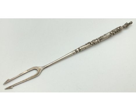 A large Chinese export silver pickle fork with Cherry Blossom decoration and figural finial. Hallmarked to handle. Approx. 22