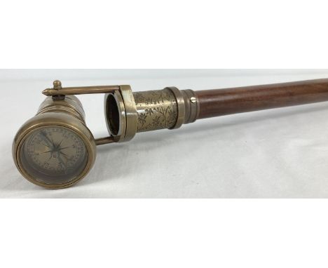 A reproduction wood and brass walking stick with swivel top telescope/compass handle. Approx. 95.5cm long in folded position.