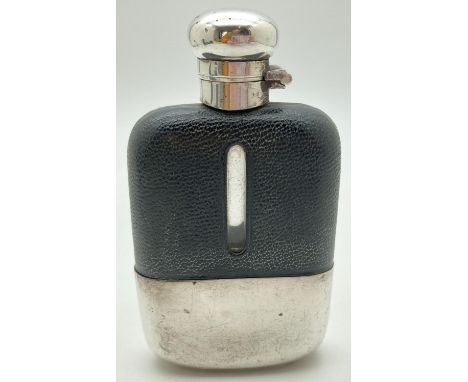 A vintage glass hip flask with silver plated detachable cup and leather bound top. Cork lined silver plated lid with twist lo