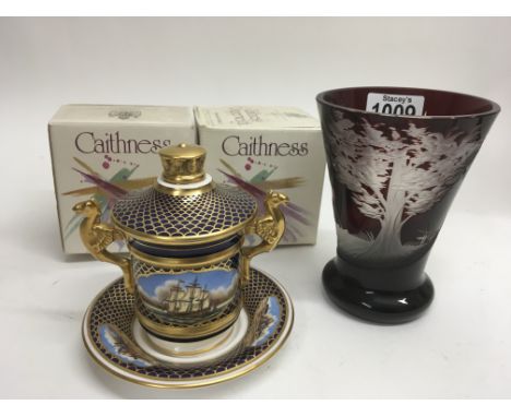 A wheel etched Ruby glass beaker two Caithness paperweights in original boxes and Spode porcelain Empire style cup and cover.