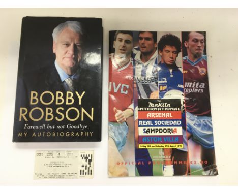 A signed Bobby Robson autobiography together with a 1990 Makita International football program and a ticket.