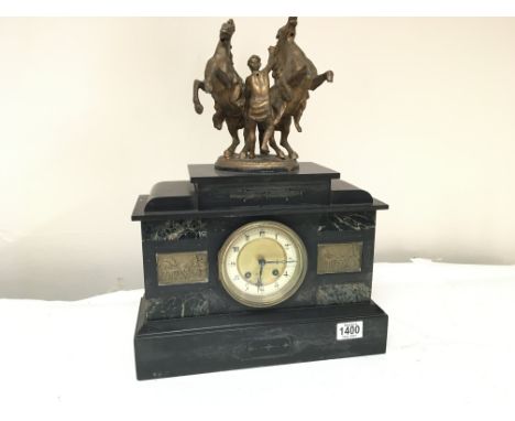 A black slate and marble mantel clock the top surmounted with Marley horses fitted with a French movement - NO RESERVE