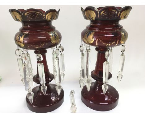 A pair of ruby glass lustres with giltwork decoration, approx height 29cm.