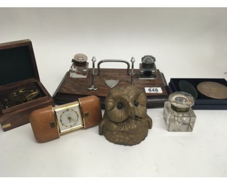 An ink well in the form of an owls head one other oak desk tray a modern portable sundial compass and other oddments.