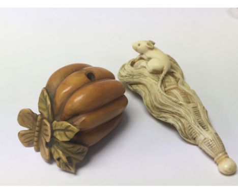 Two late 19th century Japanese Netsuke one stained and carved in the form of a pumpkin the other a mouse on woven brush. (2)