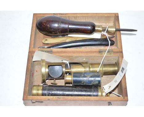 A student's microscope; a small telescope; two cut-throat razors; and a hand tool with hollow handle containing various imple