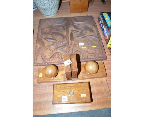 A carved wooden plaque depicting an elephant, snake and bird under a palm tree; a pair of bookends; together with a wooden bo