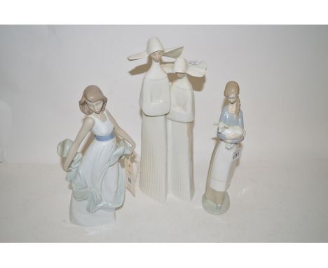 Lladro figures to include: a pair of nuns; a girl with lamb; together with a Nao figure of a girl with blue sash. (3)