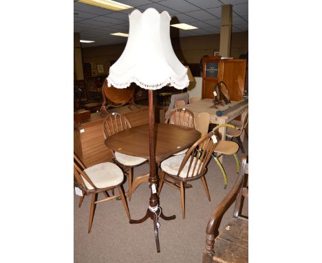 A stained wood standard lamp of reeded design.