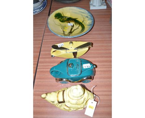 A Sadler race car teapot in green glaze; a Lingard Webster teapot; another teapot in the form of a plane; together with a Con