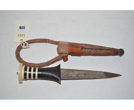 An early 20th Century dagger with double-sided pointed blade, in leather scabbard.