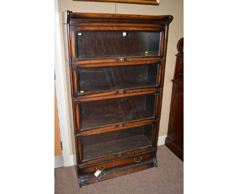 A stained oak four-tier Globe Wernicke bookcase, with single drawer under.