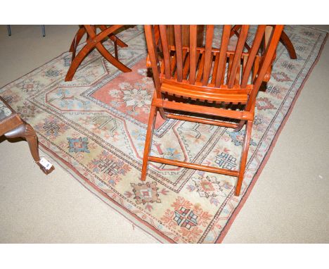 An early 20th Century Persian carpet, the field with decorative medallions within geometric border.