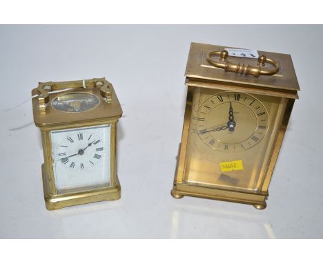 A French brass carriage clock with visible escapement; together with an Austin Wilson quartz brass carriage clock. (2)