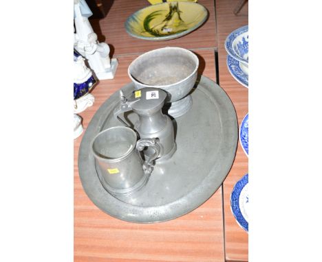 Pewter, to include: a "Tudric" oval tray; a bowl on circular foot; a tankard; and a pewter jug with cover. (4)