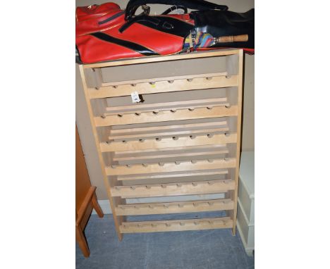 A light stained wood wine rack with seven shelves.