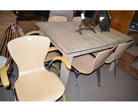 A light stained wood extending dining table, raised on square tapering legs; together with two arm and four single modern cha