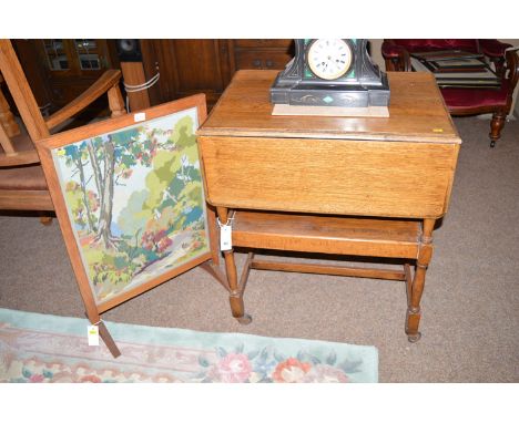An early 20th Century oak trolley; together with a firescreen.