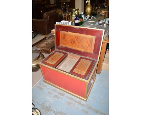 A 19th Century cabinet maker's trunk, painted gold and red, the interior with fitted trays, cupboards and compartments.