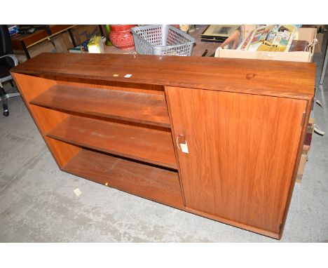 A modern teak bookcase with open shelves to left hand side and a cupboard door to the right.