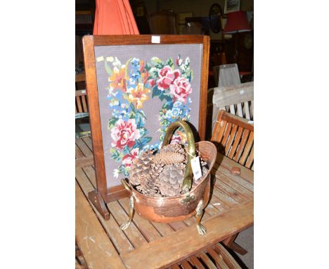 A firescreen; and a copper coal scuttle with brass handle and legs.