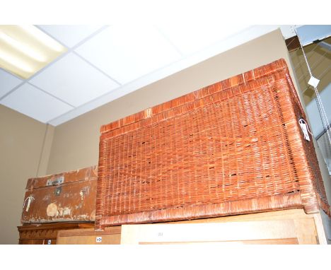 A wicker basket; and a travelling trunk.