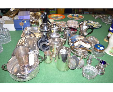 A quantity of electroplate, to include: a three-piece tea service; a dressing table set with blue enamelling; a cocktail shak